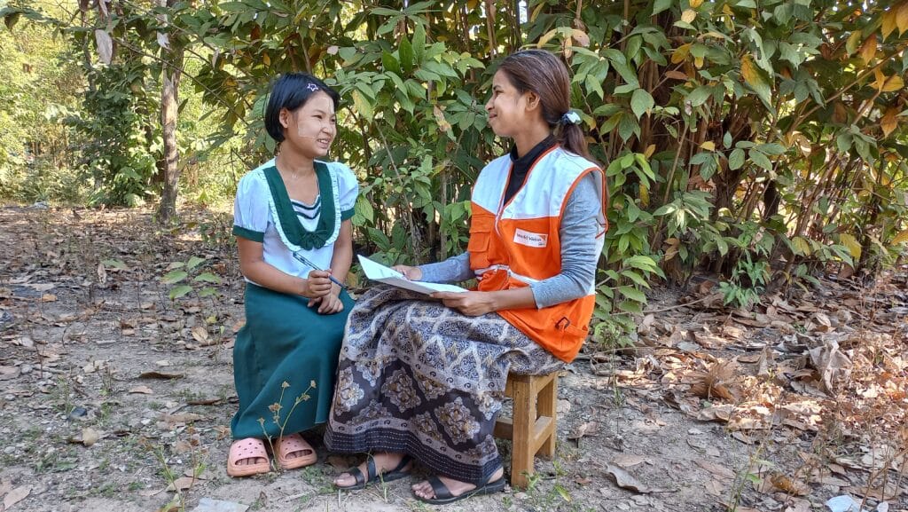 Myanmarilainen Yoon ja World Visionin työntekijä Ni Ni hymyilevät toisilleen